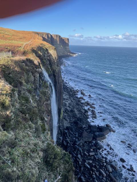       Waterfall over cliffs into the sea.
  
