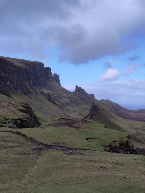       A rugged landscape with dramatic cliffs.
  