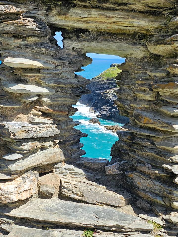 A scenic coastal view through rocky formations.