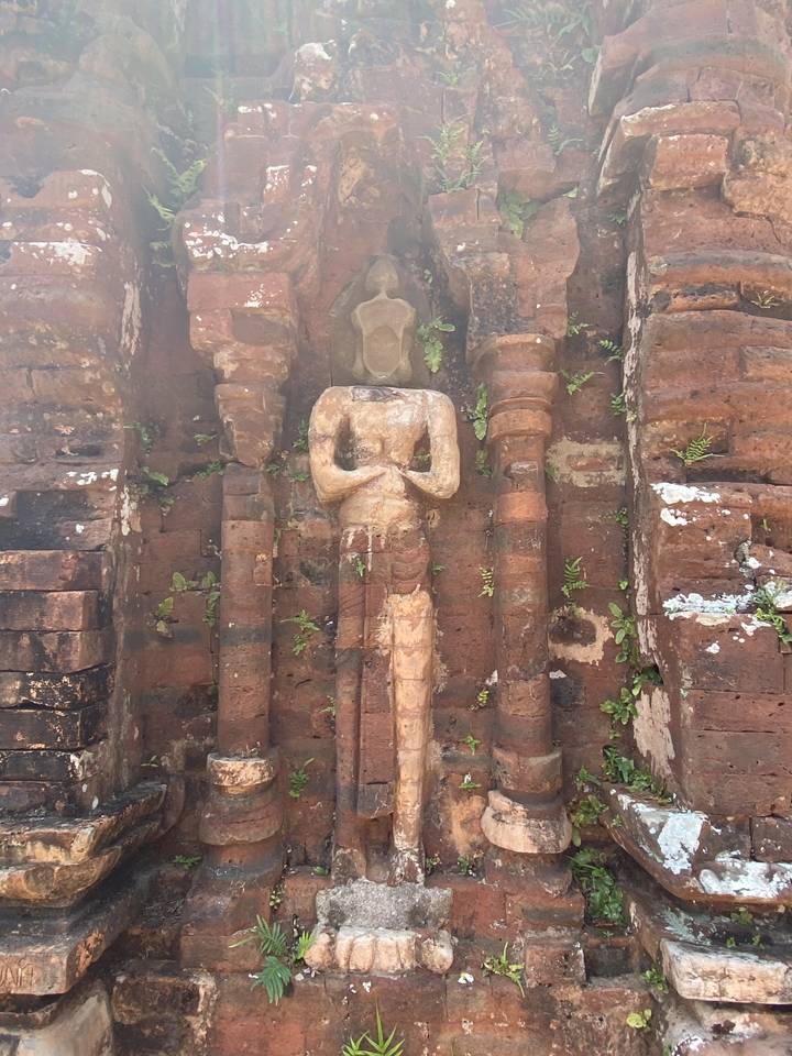 Ancient stone statue embedded in a wall.
