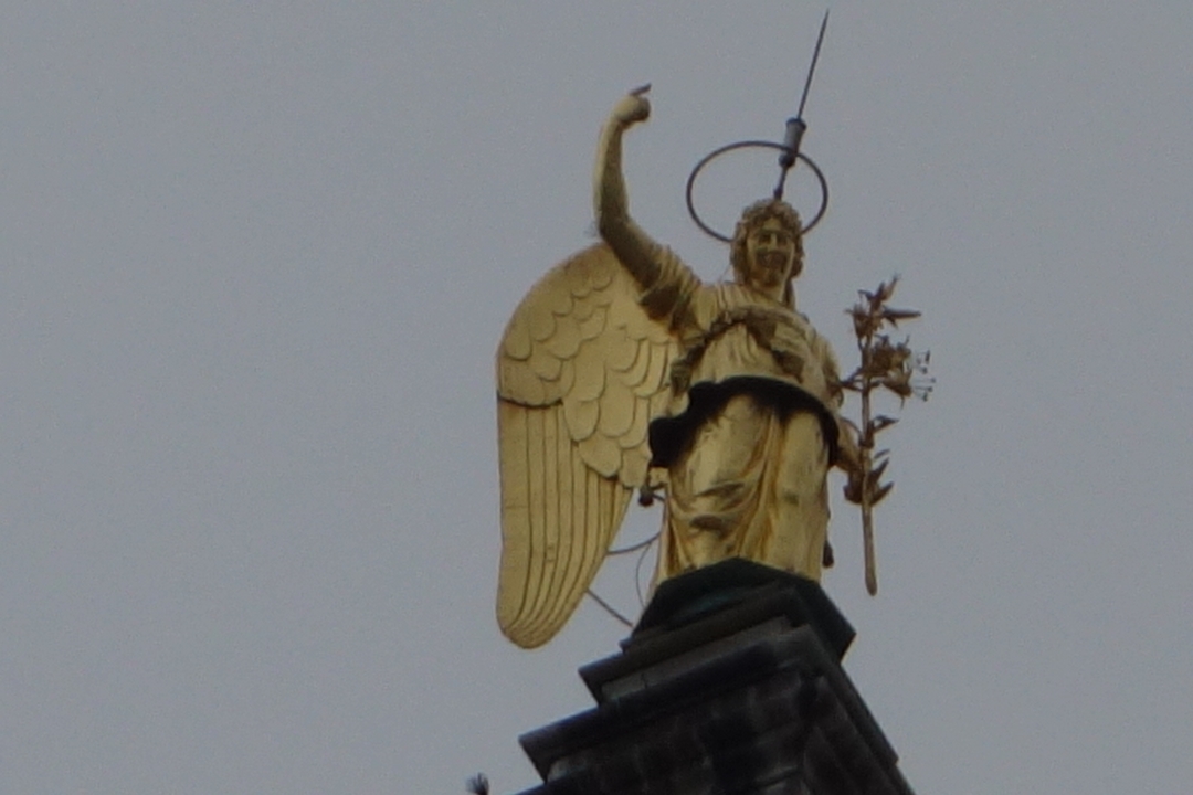 Close-up of a gold-winged statue.