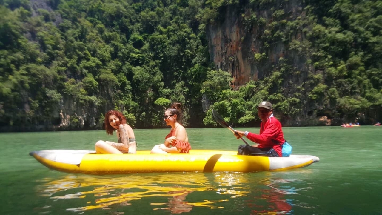 People enjoying a ride on an inflatable raft.
