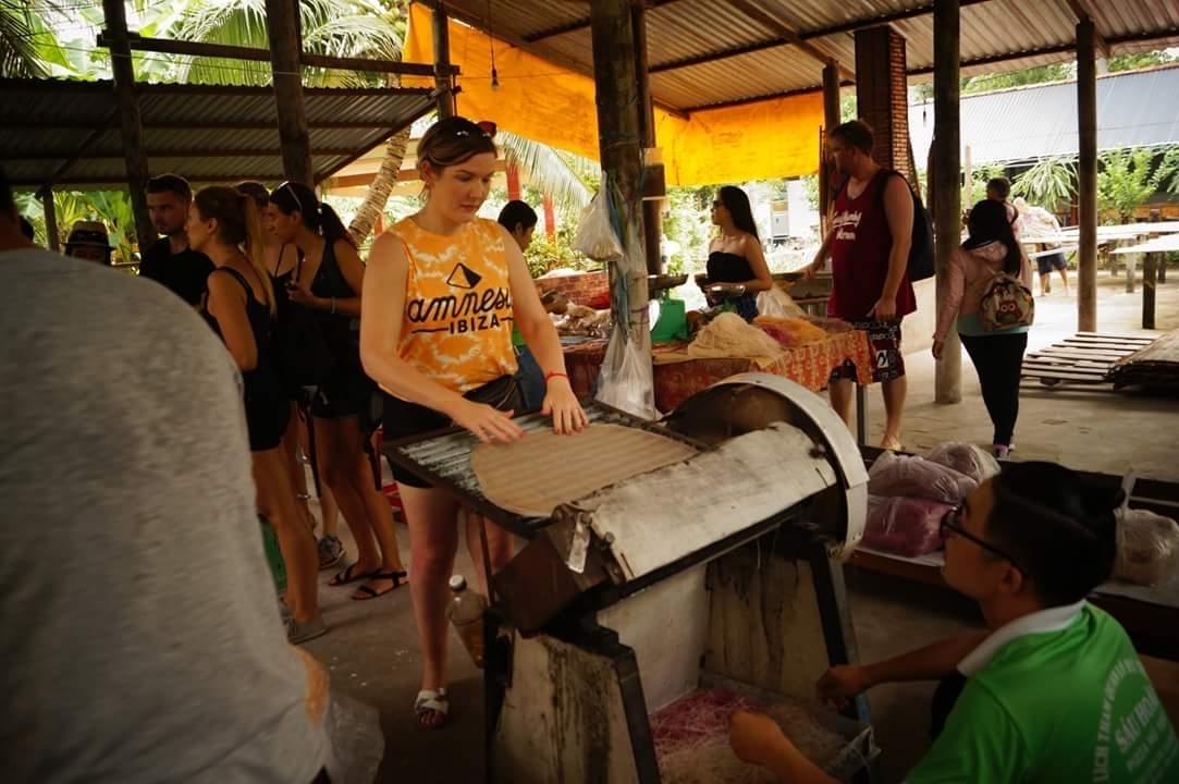 People gathered around a traditional cooking demonstration.