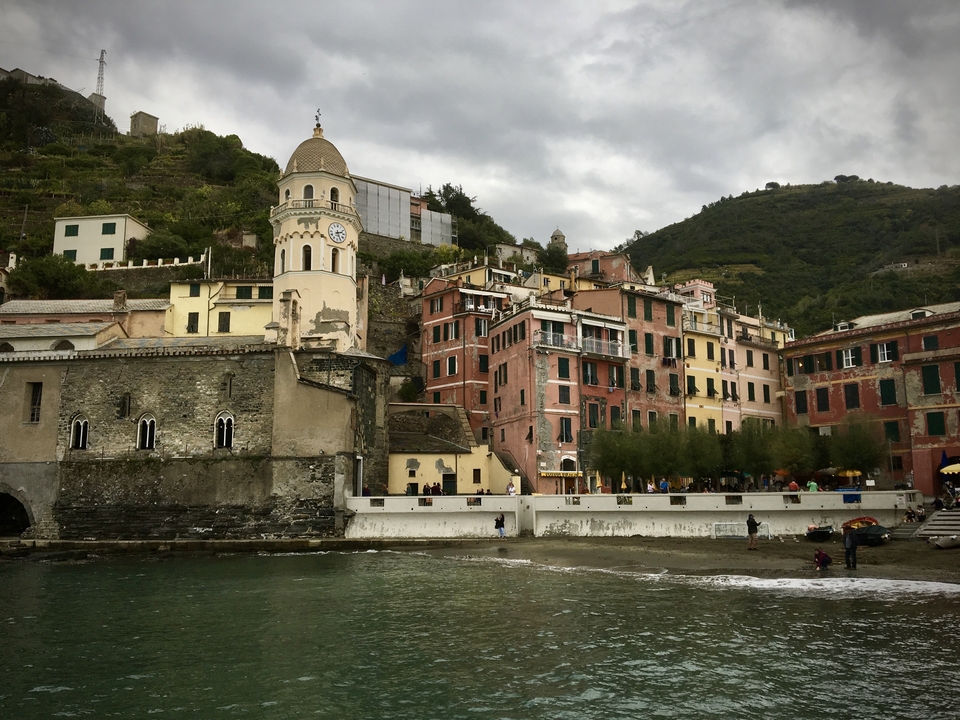 Seaside town with colorful buildings on a hillside.