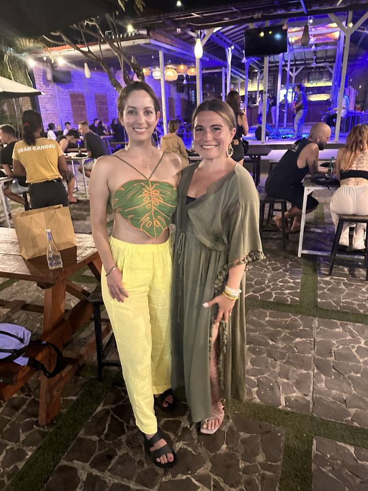 Two women posing together at a party.