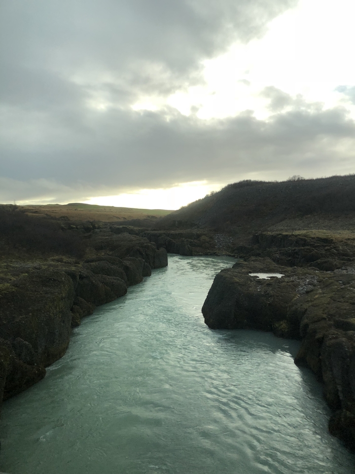 River cutting through rocky landscape at sunset.