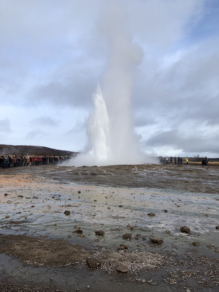 Geyser erupting with a crowd of observers.
