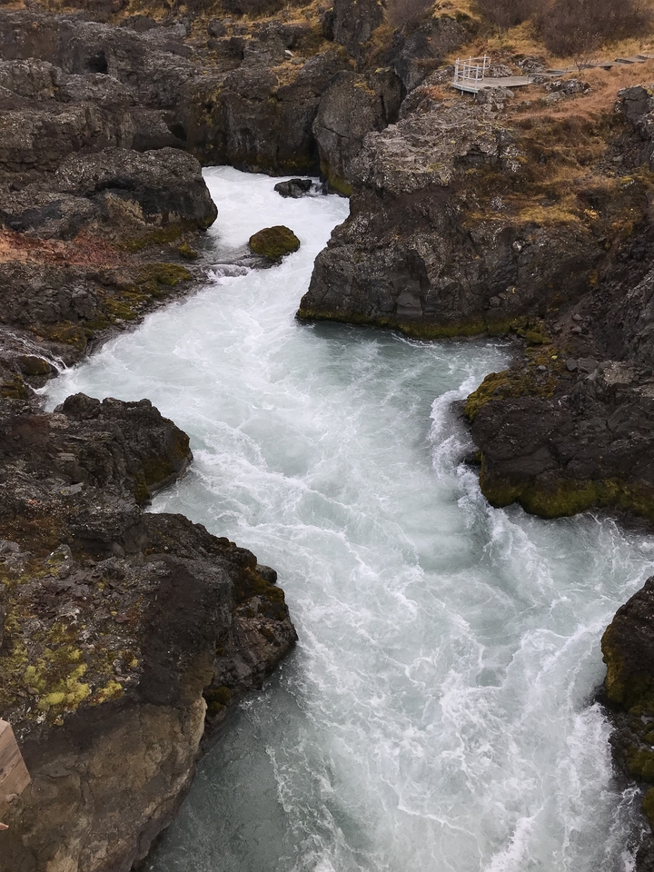 Rushing waters in a rocky canyon.