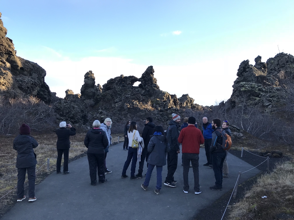 Group of people exploring lava rock formations.