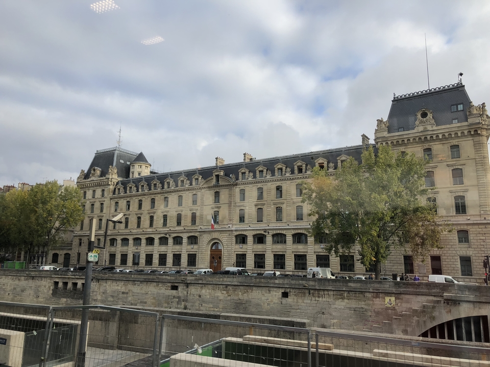 Un grand bâtiment historique avec des drapeaux français.