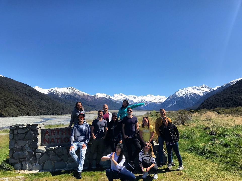 Group of people posing in a mountainous area.