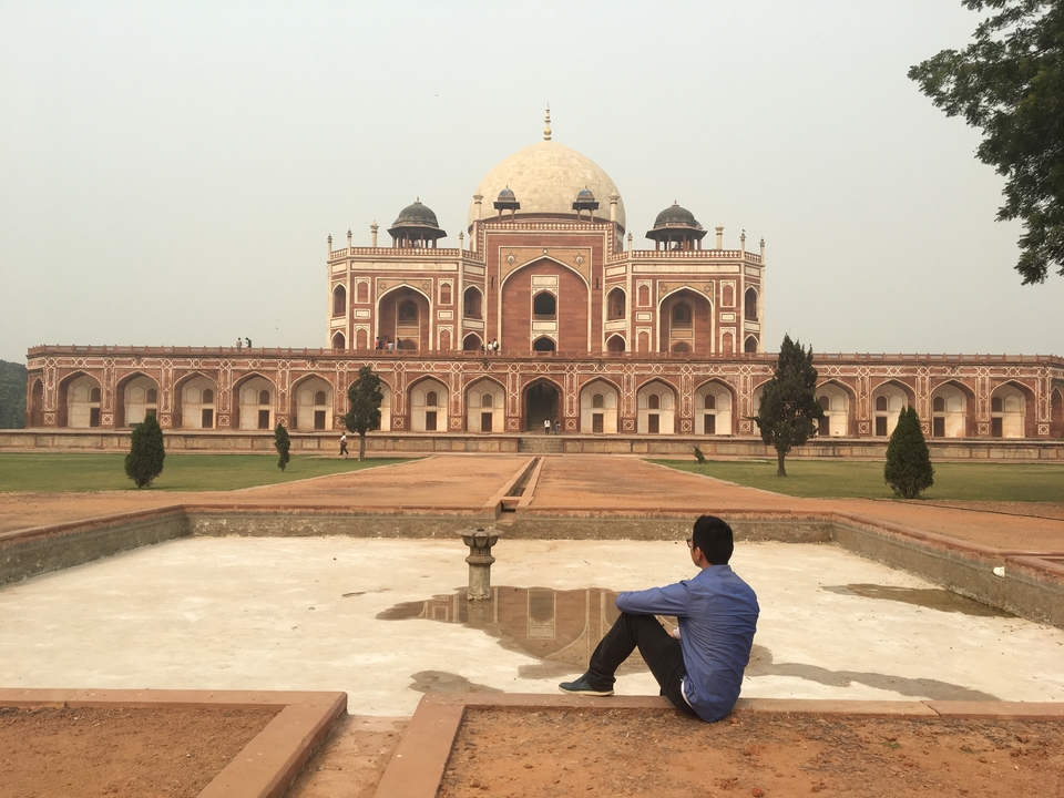 Man sitting in front of Humayun's Tomb.