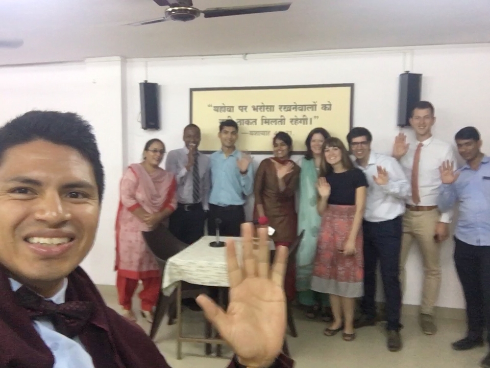 Group inside a room with a sign on the wall.