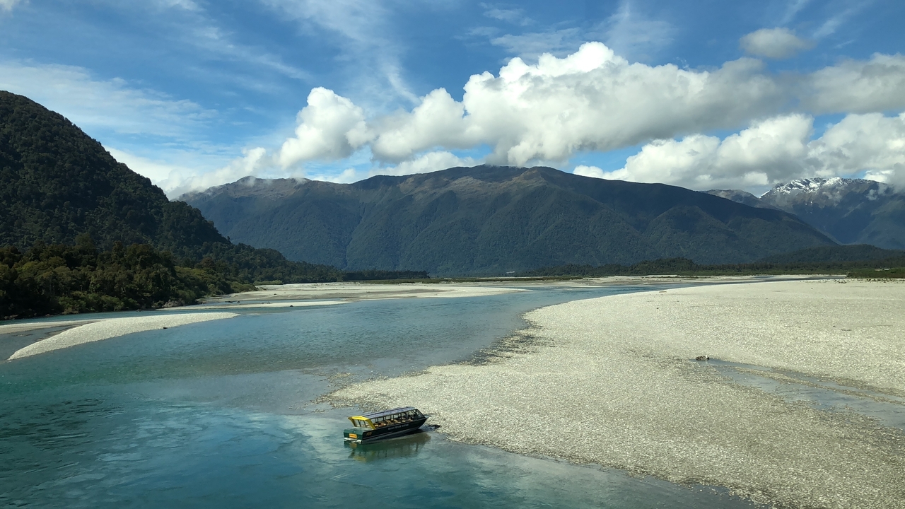 Wide river scene with distant mountains.
