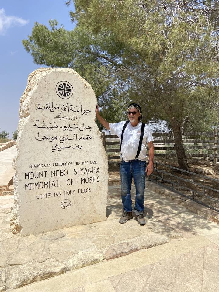 Man standing next to Mount Nebo memorial stone.
