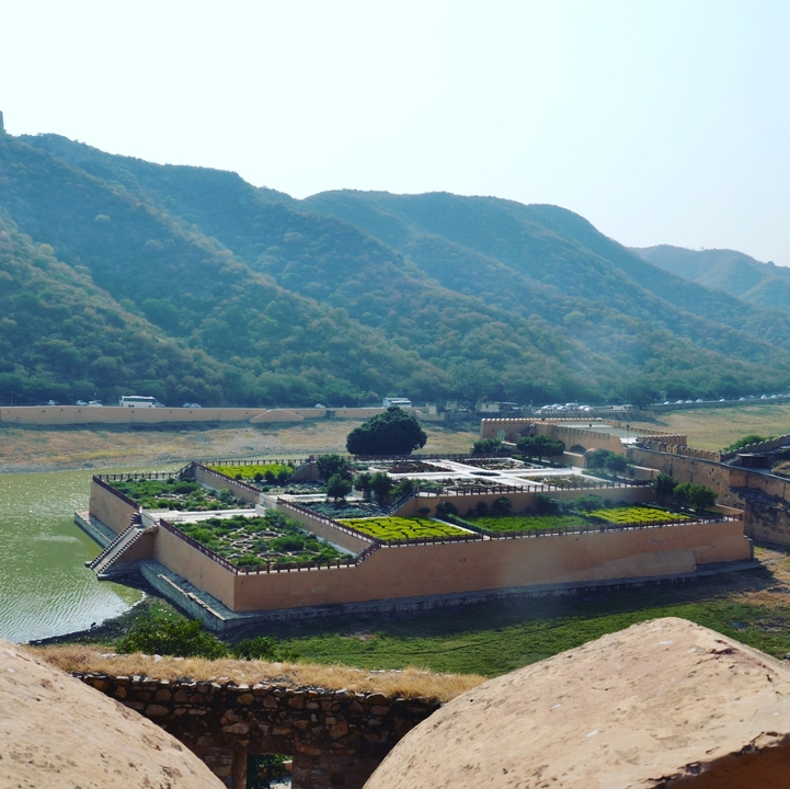 Garden enclosed by walls with mountains in the background
