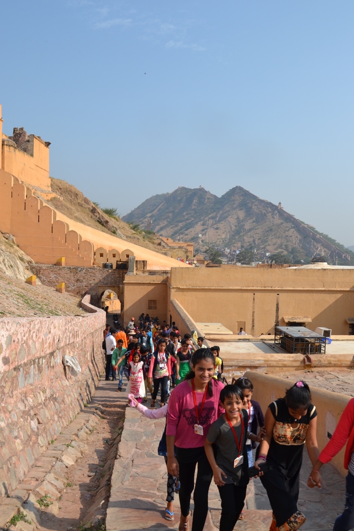 Fort with mountains in the background and a crowd of people