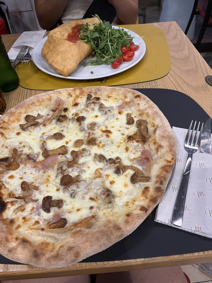 Pizza with mushrooms and cheese on a table