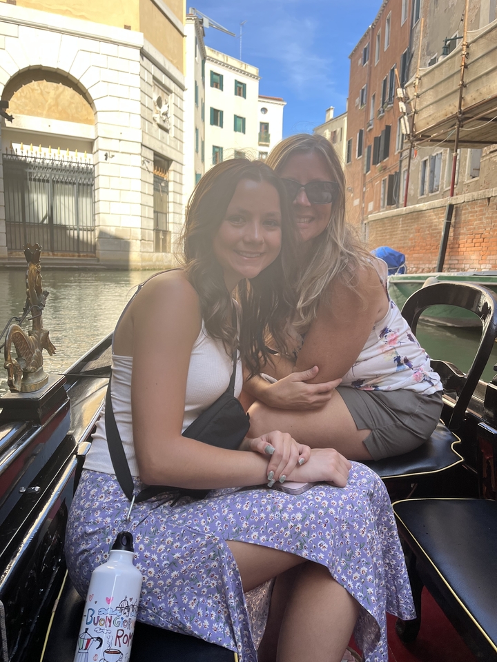 Two women on a gondola ride in a canal