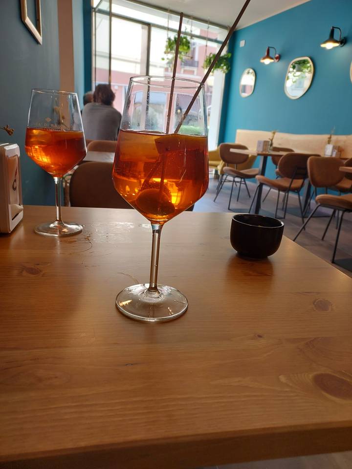 Glasses of orange drink on a wooden table in a cafe.