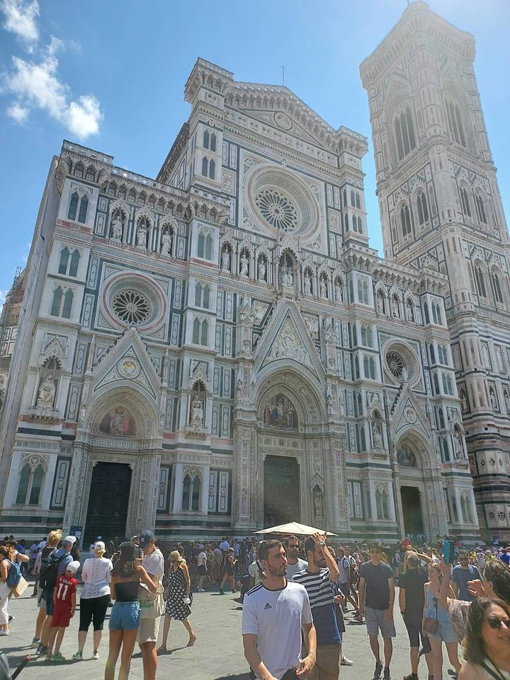 Facade of a cathedral with white marble and colorful geometric patterns.