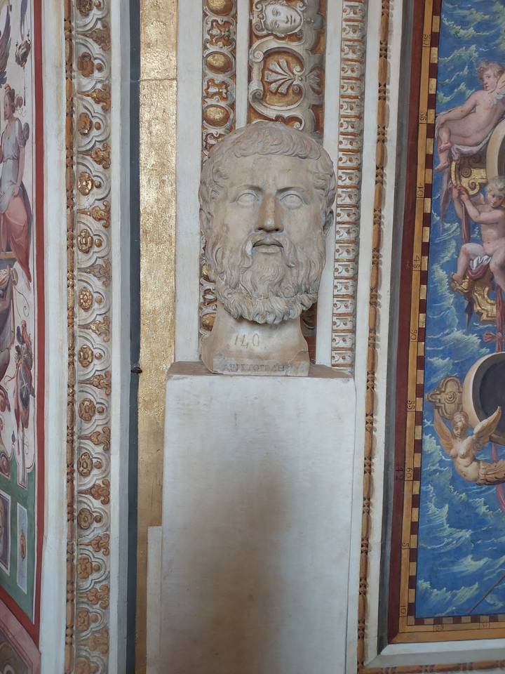 Bust of a bearded man on a pedestal.