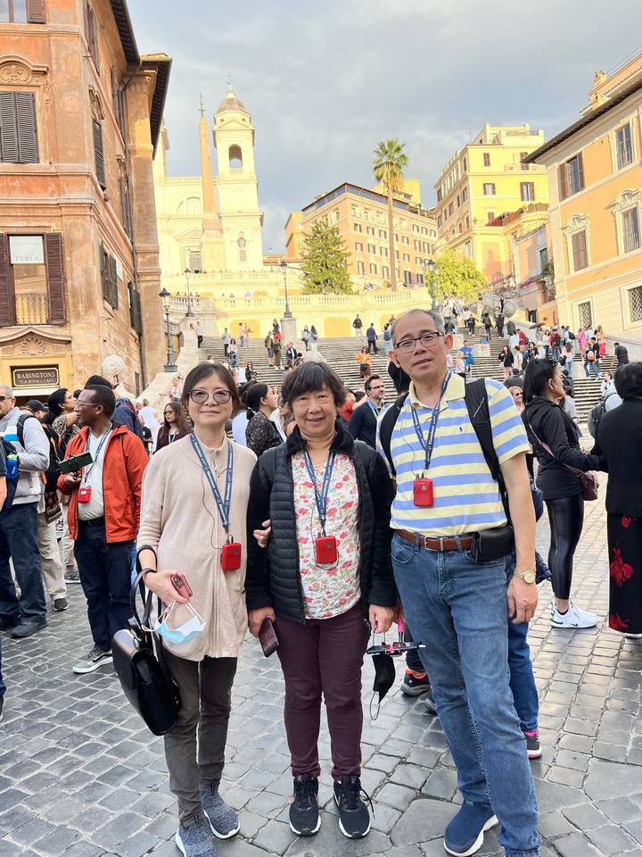 A group posing in a European square with historic architecture.
