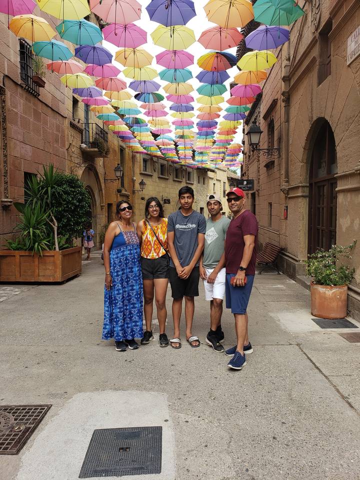 Group of people standing under colorful umbrellas