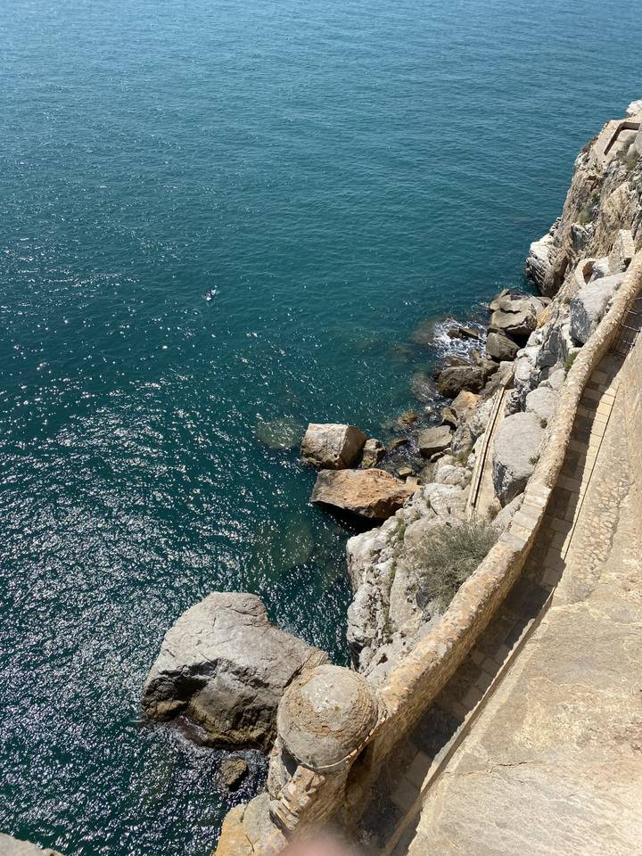 A rocky coastline with clear blue water.