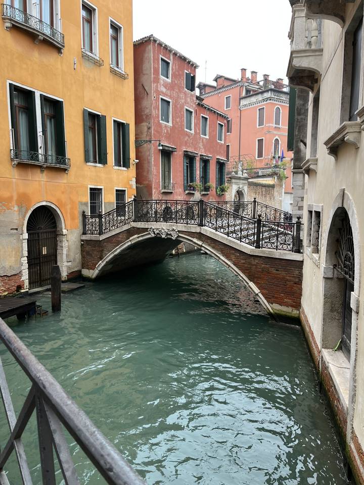 Canal vénitien avec des bâtiments colorés et un pont.