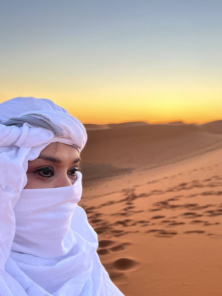 Gros plan d'une personne avec un turban dans le désert.