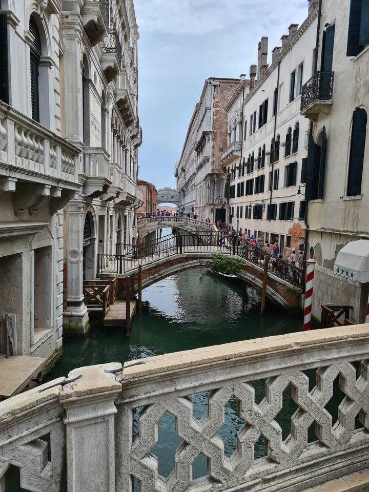 Venetian canal with gondolas and old buildings.