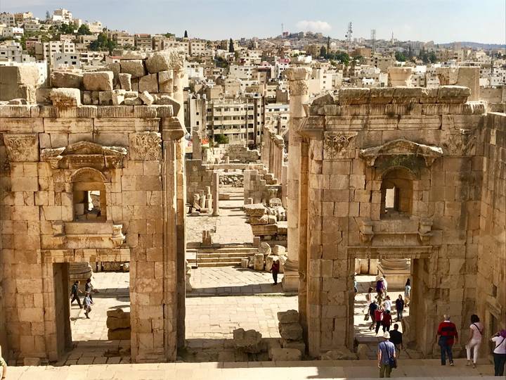 Ancient ruins with modern city in the background.