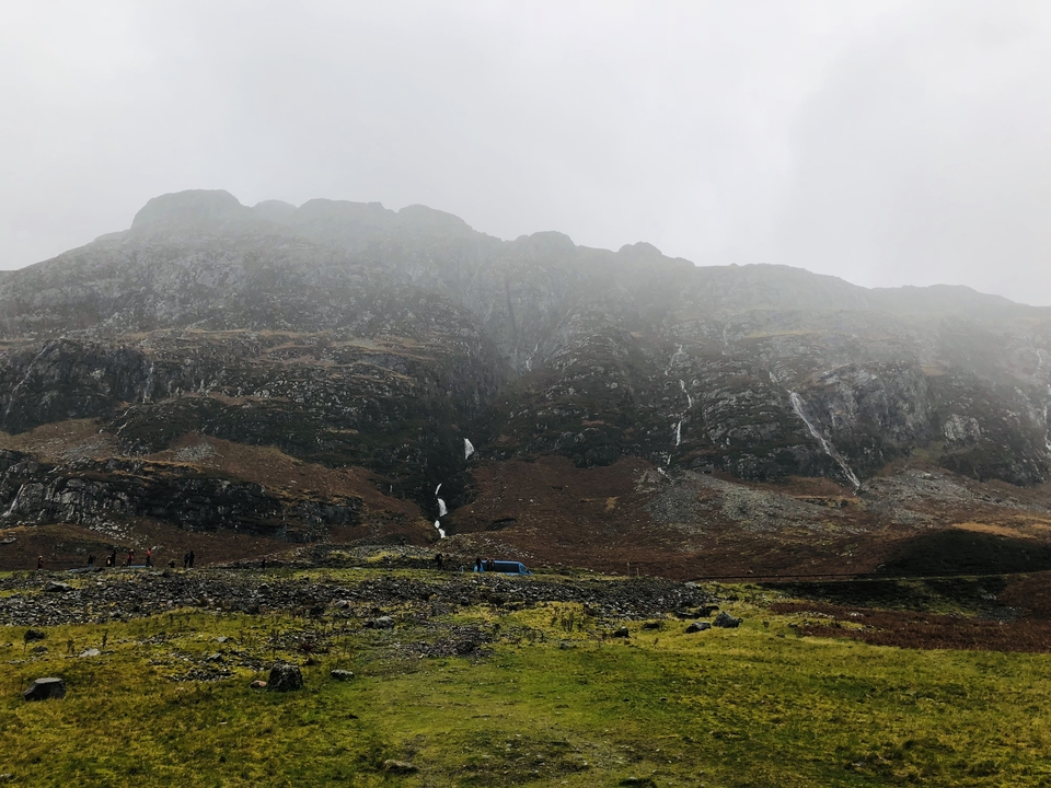 Majestic mountains with waterfalls cascading down the slopes.