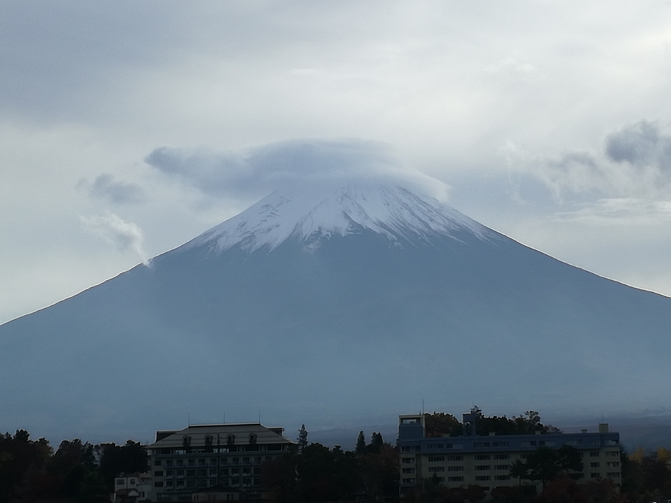 Mount Fuji with clouds at the peak.