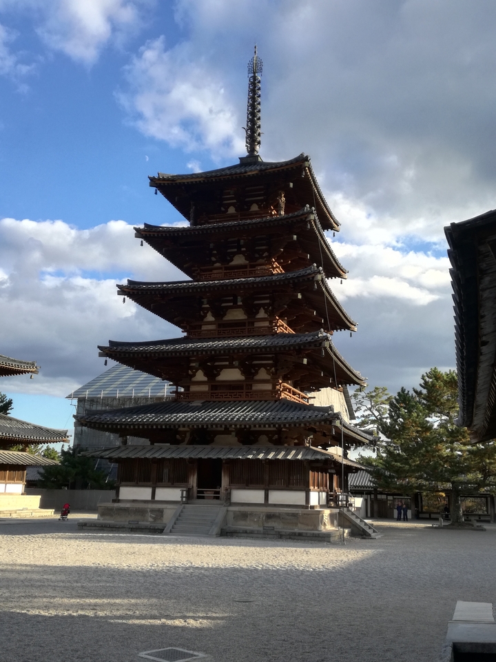 Traditional Japanese pagoda against a cloudy sky.