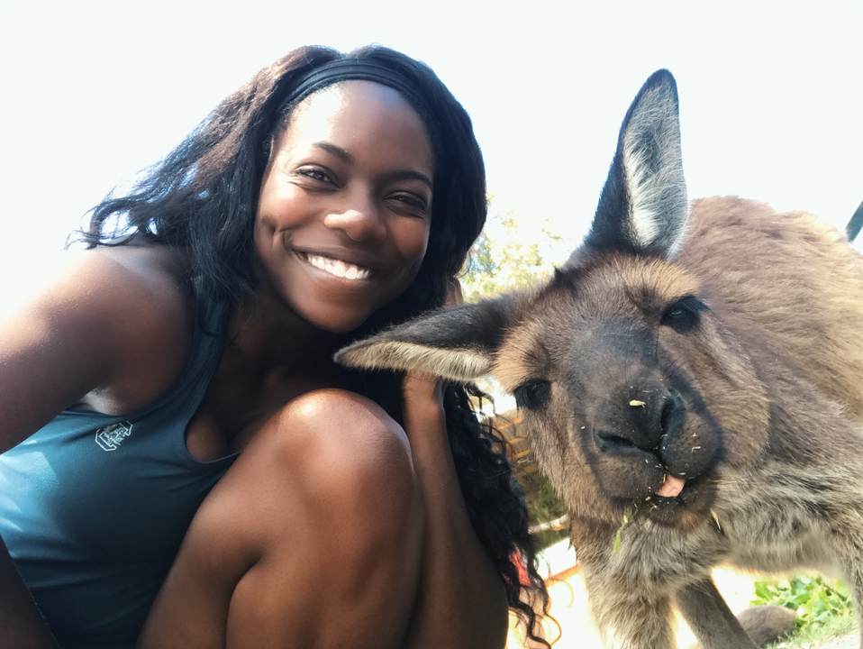 A person taking a selfie with a kangaroo.