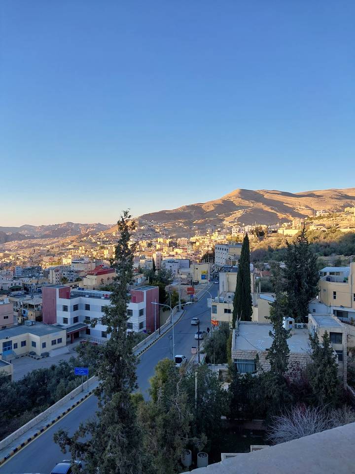 City landscape view with mountains in the background.