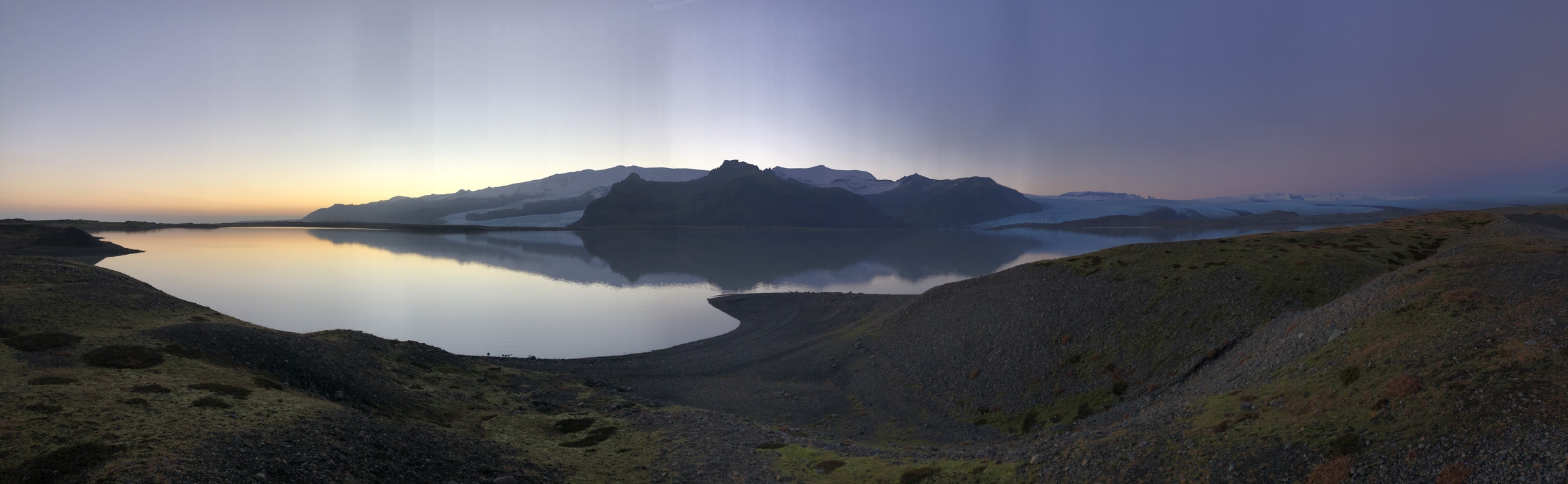 Mountain reflected in a calm lake at sunset.