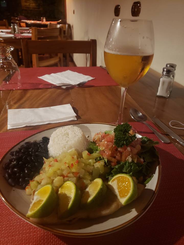 Traditional meal with rice, beans, and lime slices.