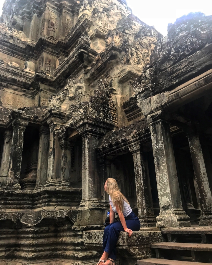 Person at the entrance of an ancient temple.