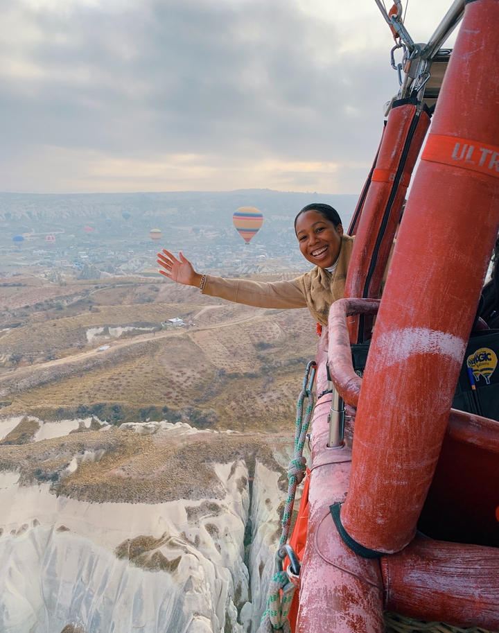 A woman enjoying a hot air balloon ride in Cappadocia.