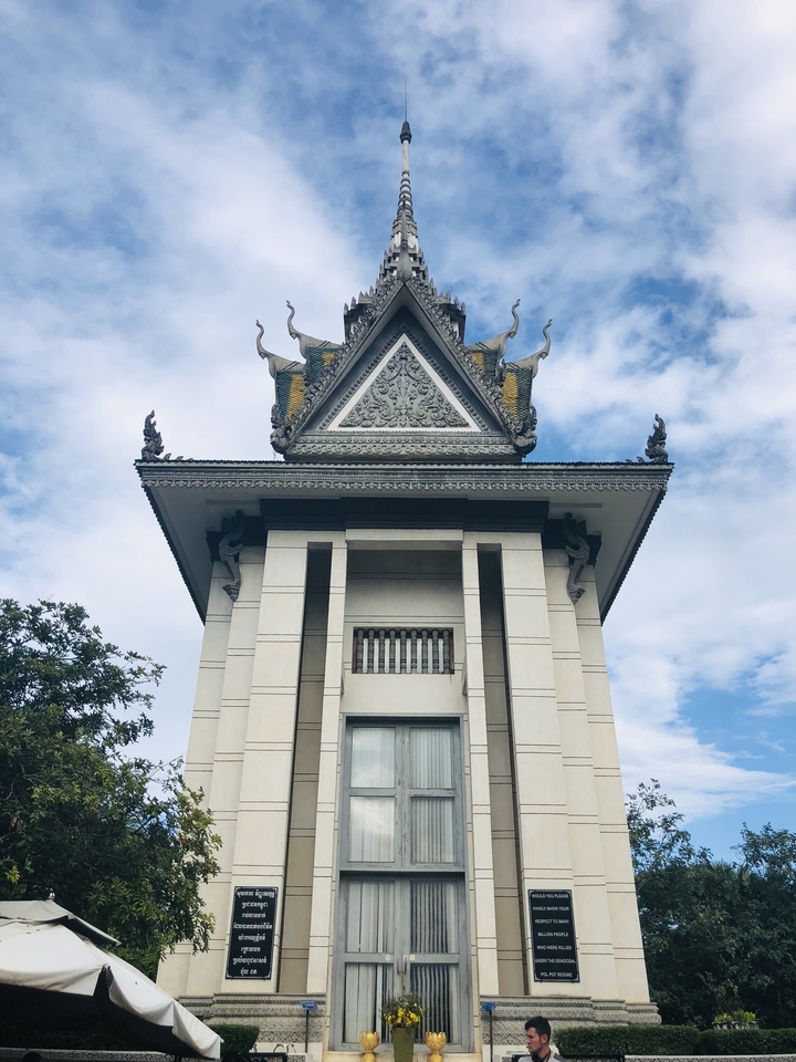 An intricately designed Khmer temple against a blue sky.