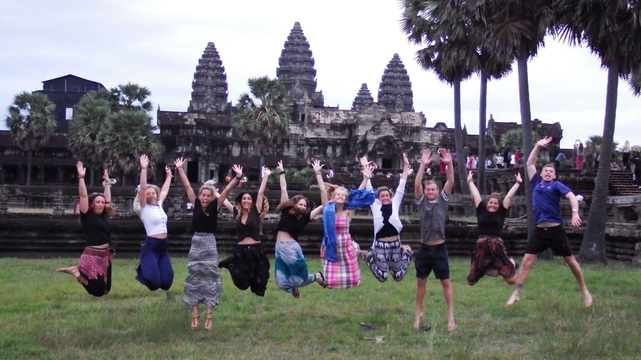 Group jumping with enthusiasm in front of Angkor Wat.