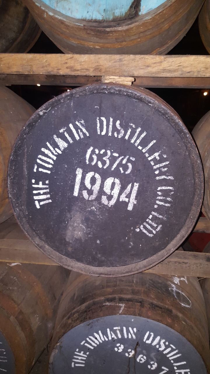 Close-up of a distillery barrel head with text.