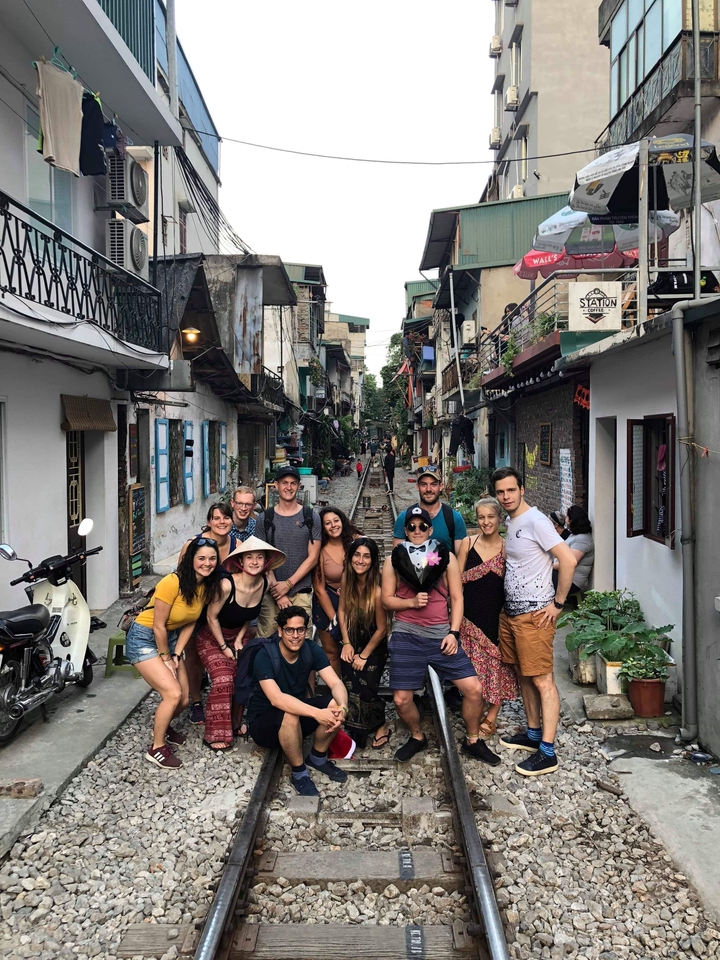 Group of people posing in an alleyway.