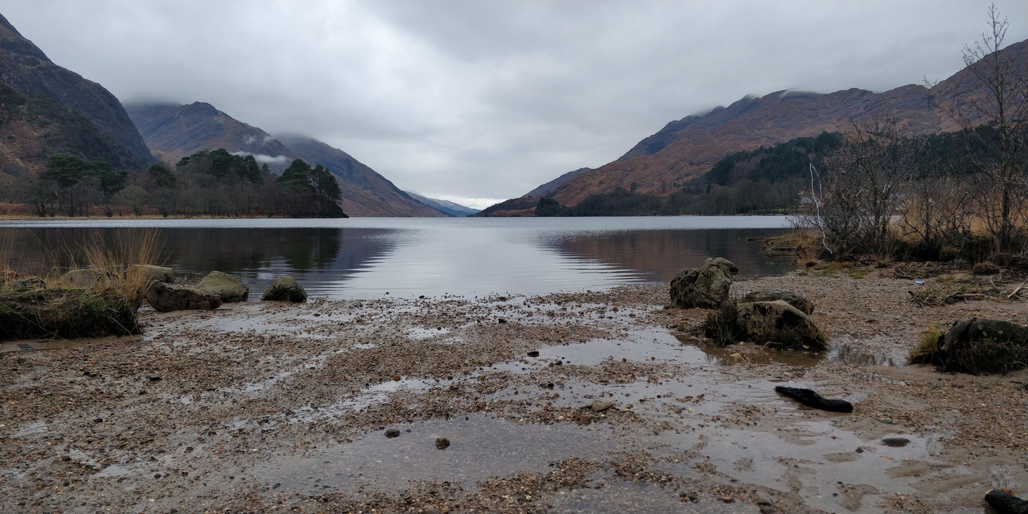 A tranquil lake with mountains in the distance.