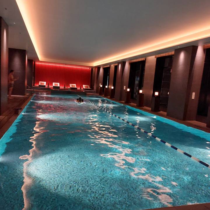 Indoor swimming pool with a person swimming.