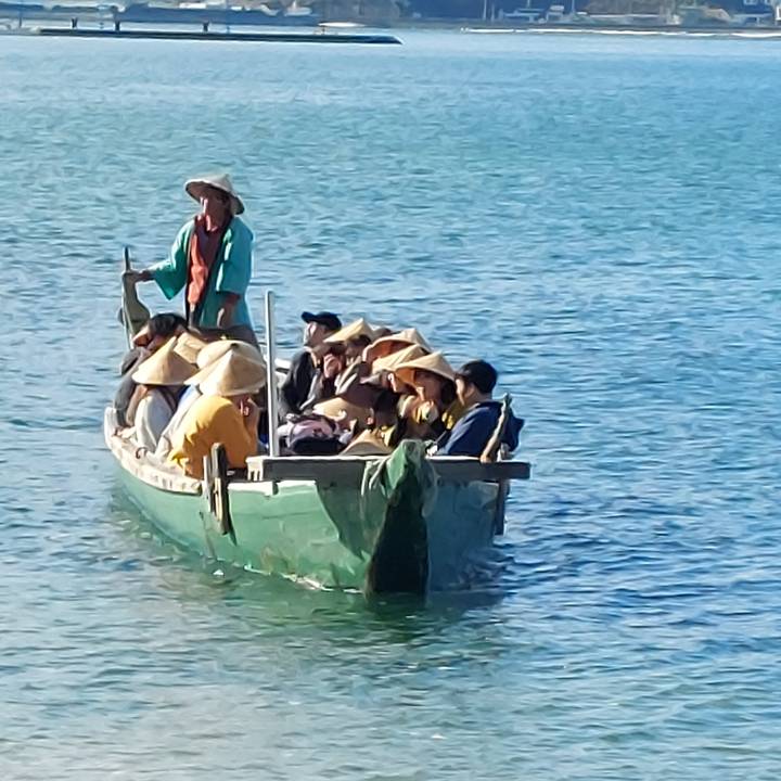 Group of people in a boat on the water.
