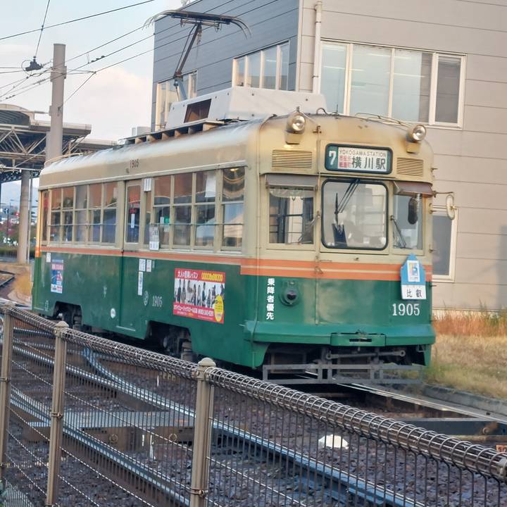 Vintage tram on tracks in a city.